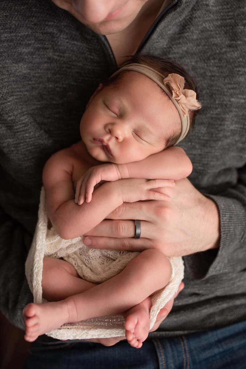 Green Lake Newborn Photo baby in daddy's hands | Glory Be Photography by Tara Bos