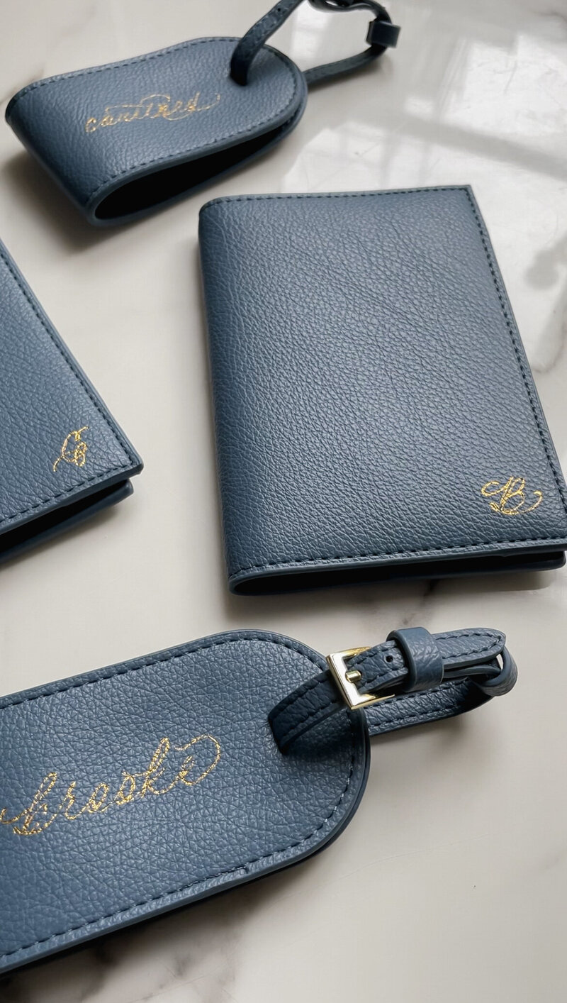 Navy blue leather luggage tags and passport books with custom gold hot foil calligraphy