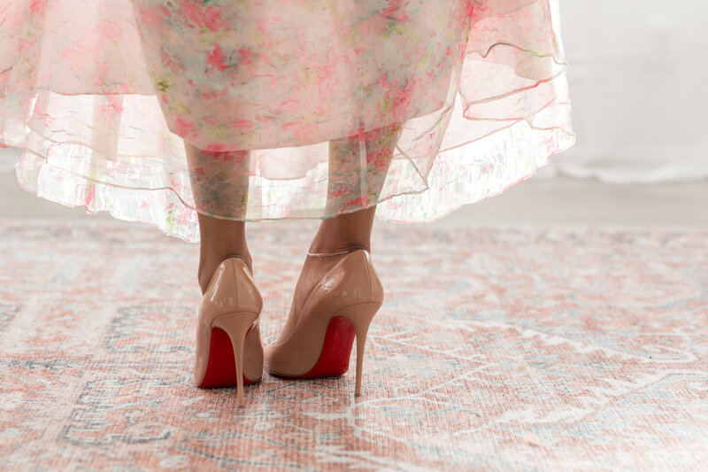 Tahirah smiling, holding a book titled "The Little Dictionary of Fashion"
