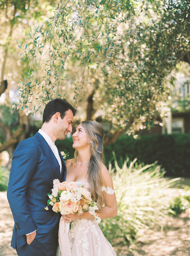 Newlywed couple under a tree at their celebration, planned by San Francisco wedding planners Jacinda Weddings & Events.