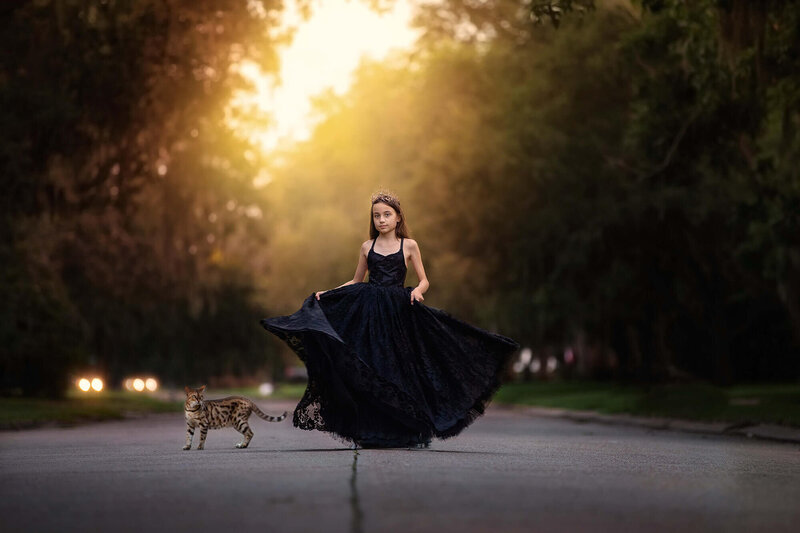 Beautiful tween girl and her bengal cat in the middle of the road in Houston.
