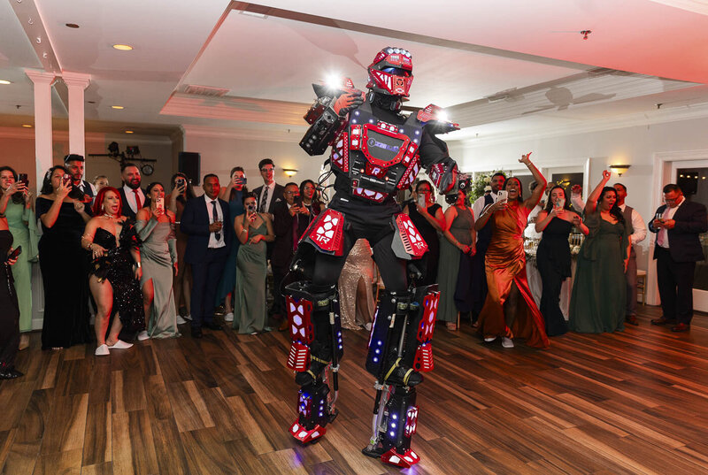 a person dressed like a robot dancing at a wedding