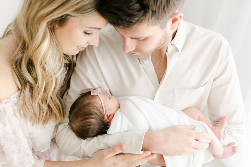 Newborn Baby Sleeping with Parents Hands