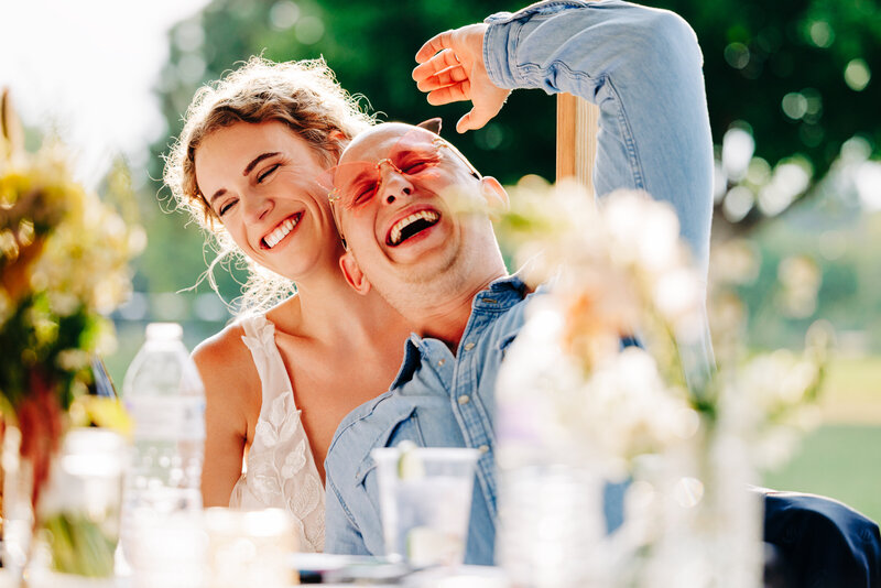 Western Montana bride and groom laughing hysterically at outdoor reception