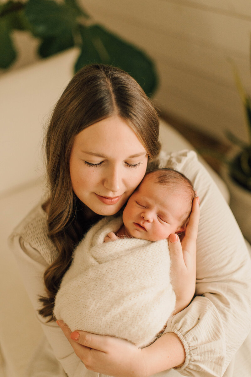 wrapped newborn baby with mom pose