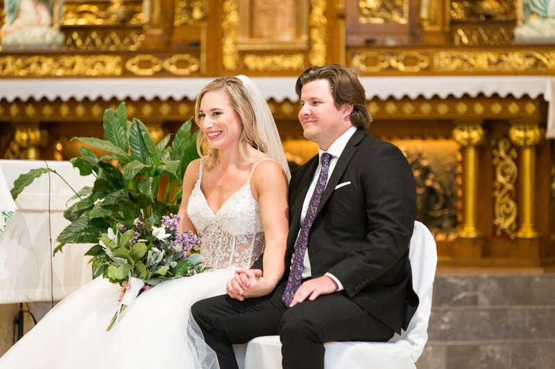 bride and groom laughing during wedding at st. john cantius church