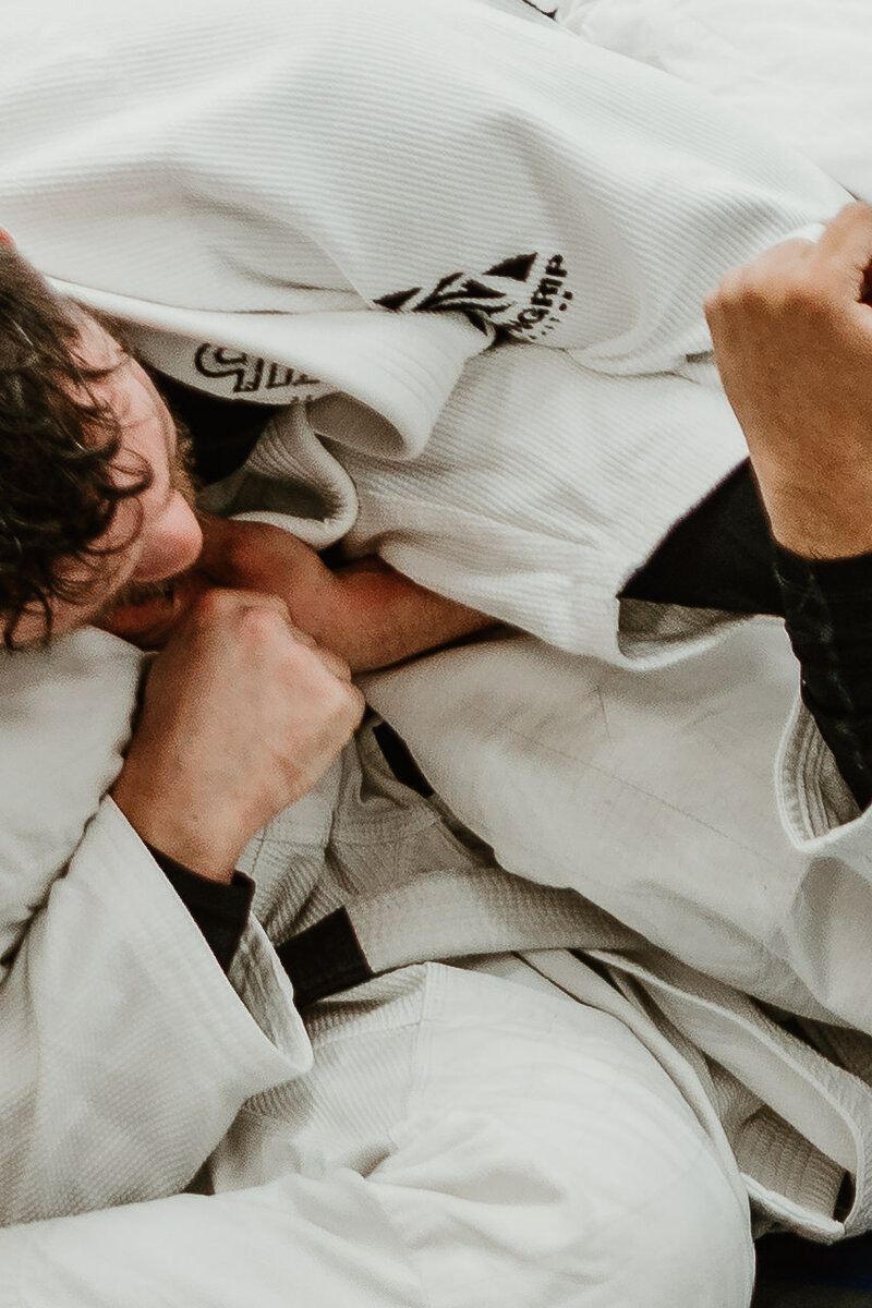 Up close photo of two men drilling an armbar at IRONGRIP