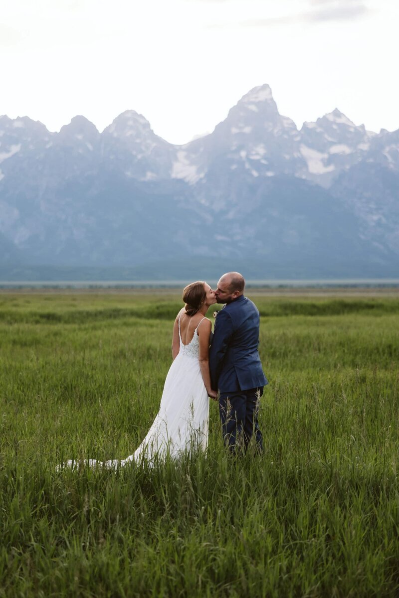 A couple looking into each others eyes laughing in the Sawtooth mountains in Stanley, Idaho