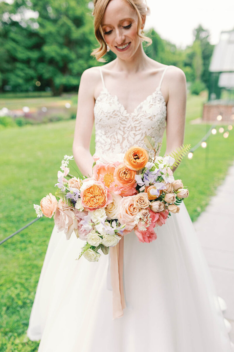 True to color documentary style wedding portraits, bride holding colorful flower bouquet