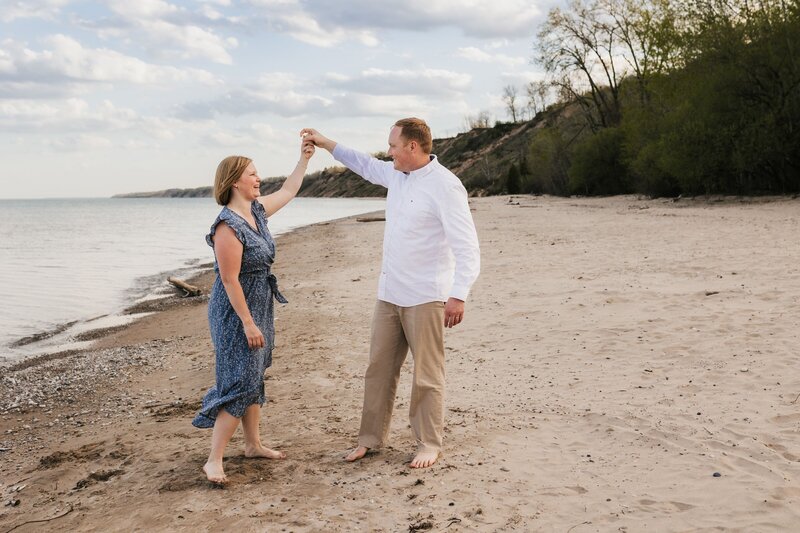 husband and wife dancing on the beach in port washington