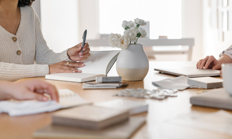 Girl holding the pen with a book