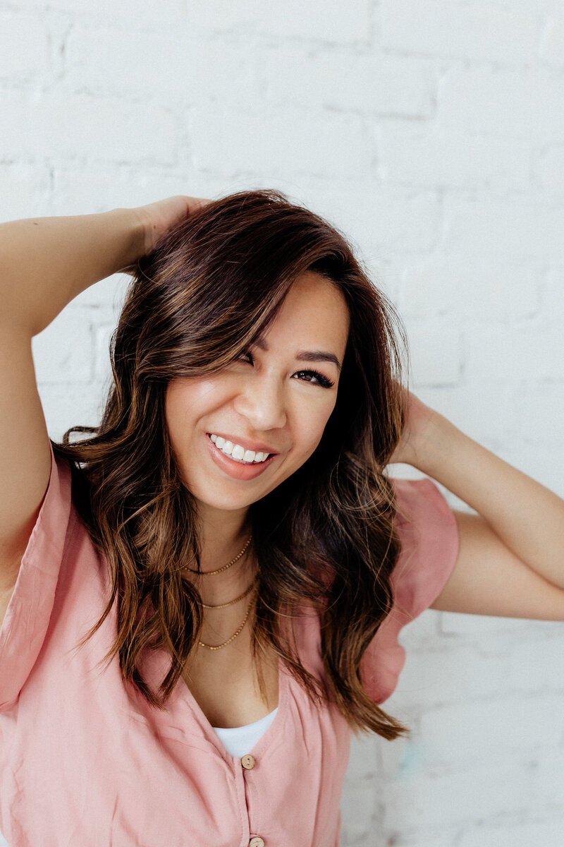 woman smiling in pink shirt
