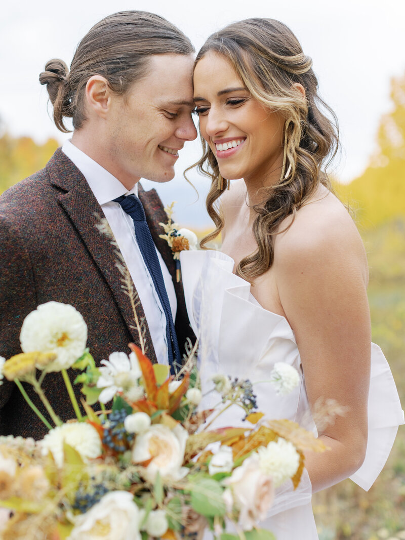 bride-and-groom-smiling-at-their-fall-wedding-in-utah