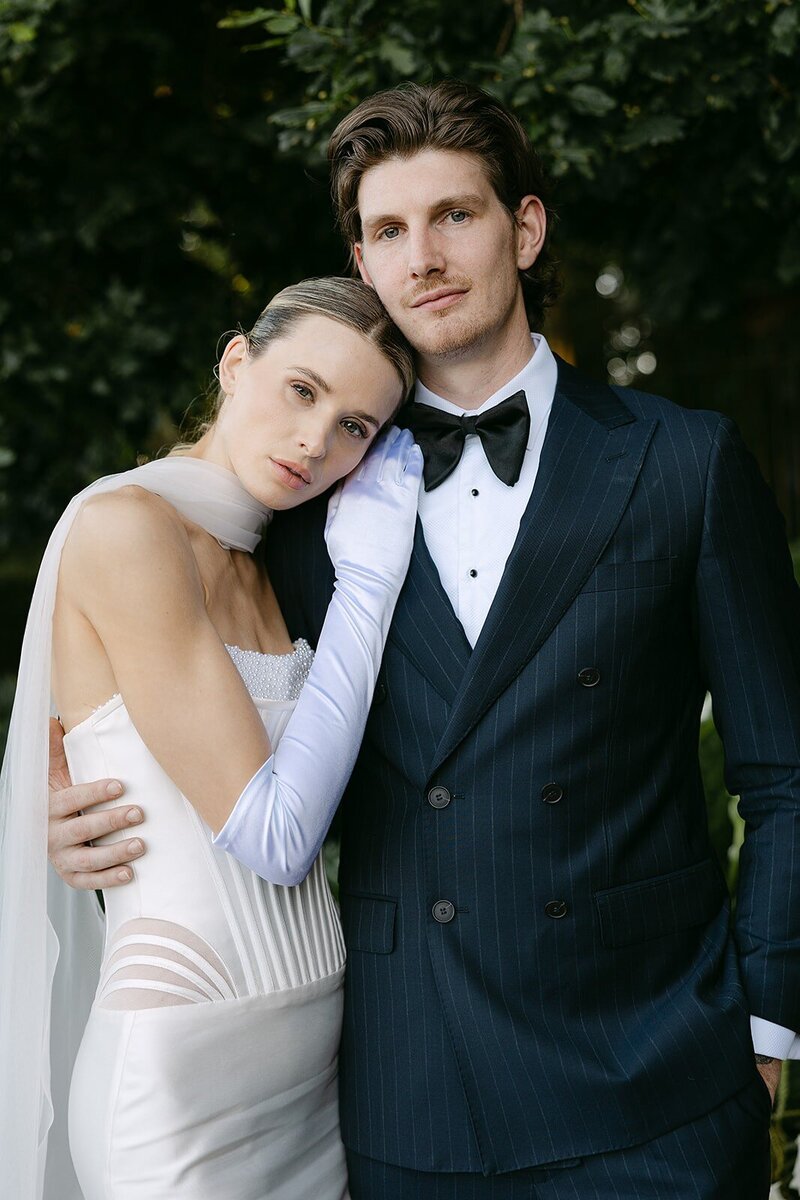 Bride with groom leaning on his shoulder