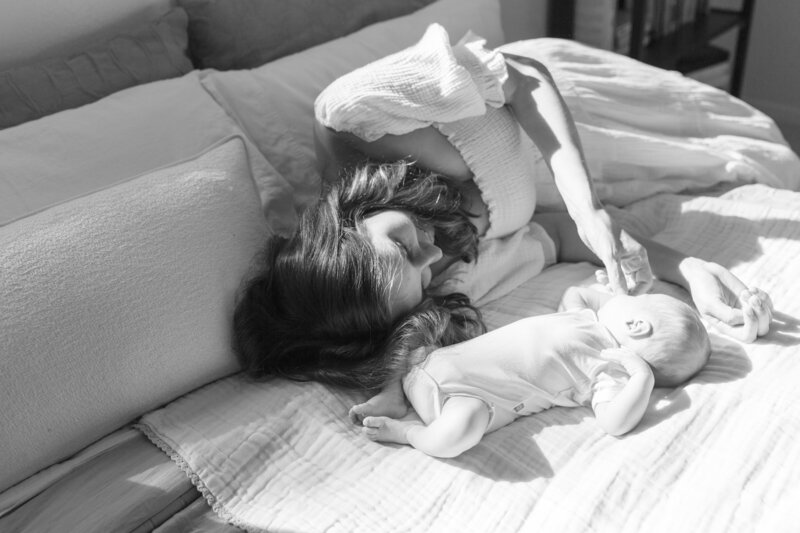 mother and son snuggling on a bed in a portland home