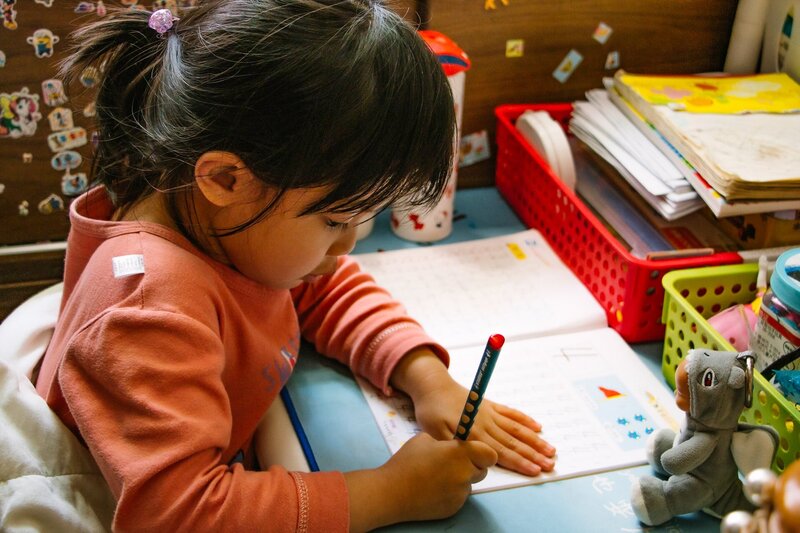 A young Indigenous girl completes school work on-reserve