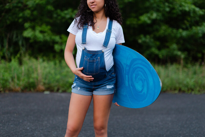 Maternity session holding her longboard
