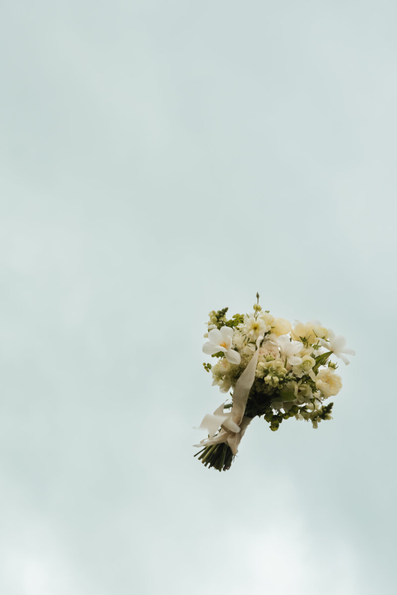 Close-up of a wedding bouquet featuring a beautiful mix of flowers, captured in a detailed shot.