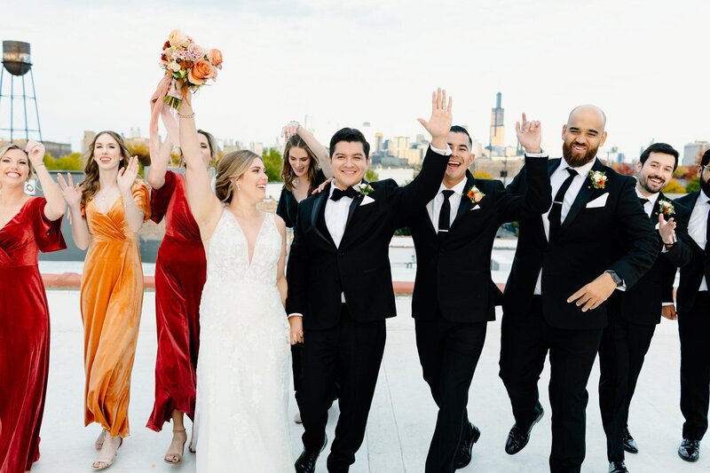 Bride and groom cheering on the rooftop at the Walden in Chicago Illinois