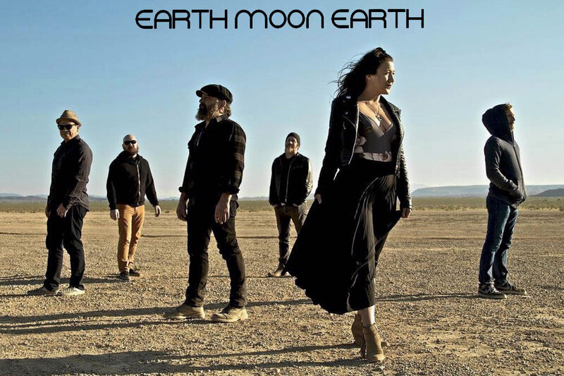 band promotional poster Earth Moon Earth members standing in desert