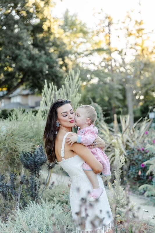 Cassandra with her young daughter in a garden