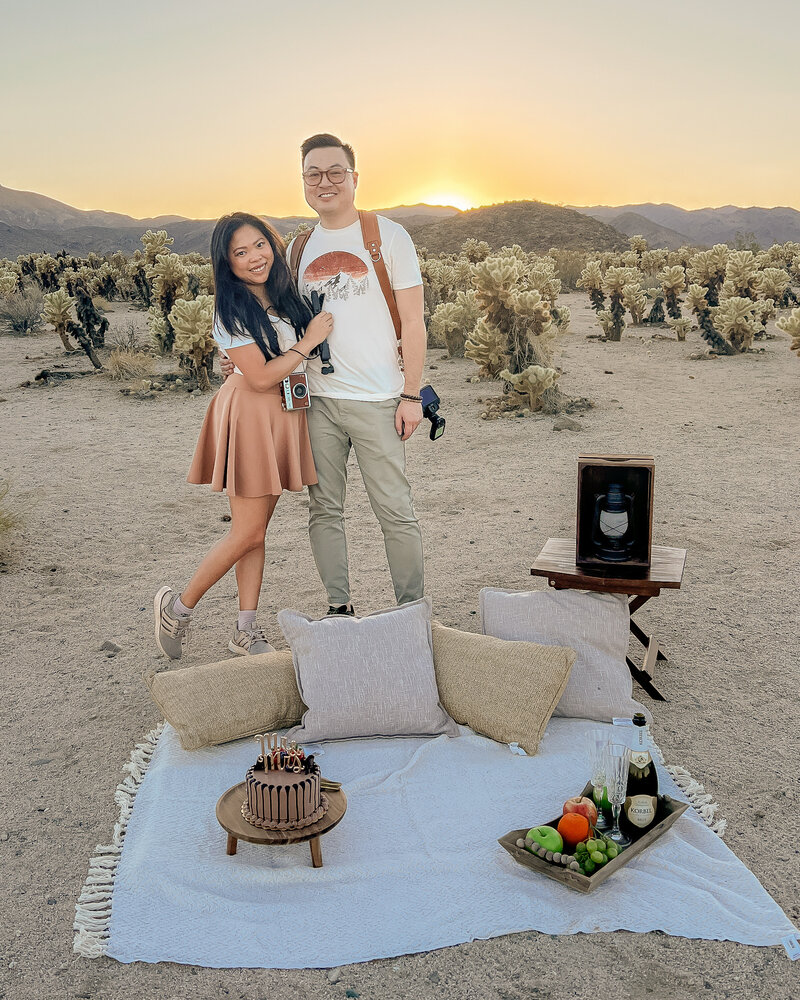 Peter 3 Photography, a Joshua Tree Elopement Photographer and adventurous intimate wedding photographer at Cholla Cactus Garden setting up an elopement picnic.