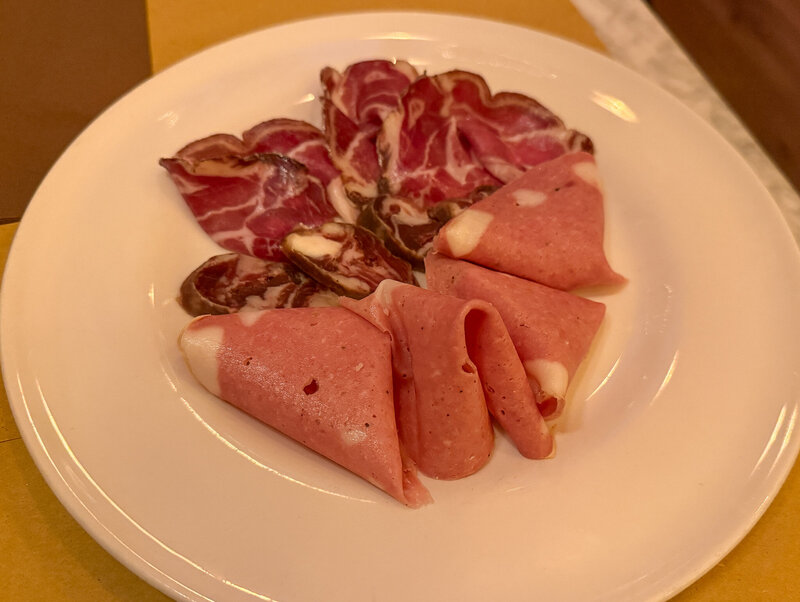 Freshly sliced meats at Latteria Trastevere in Rome, Italy
