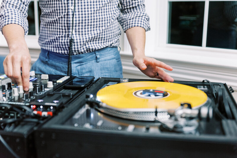 a beautiful naked young female dj puts a records on a turntable