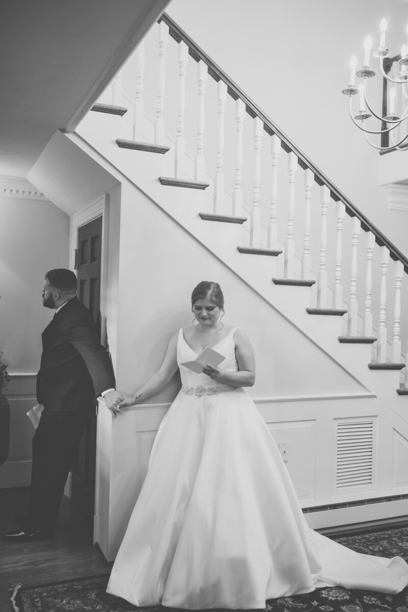 Bride smiling during first touch at Wrightsville Manor wedding reception – fine art coastal wedding photography