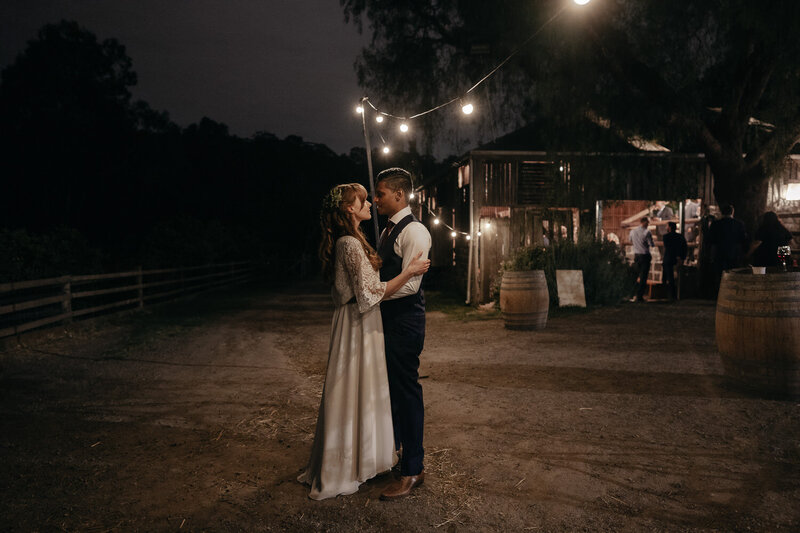 couple standing under festoons at Collingwood Childrens Farm Wedding Melbourne