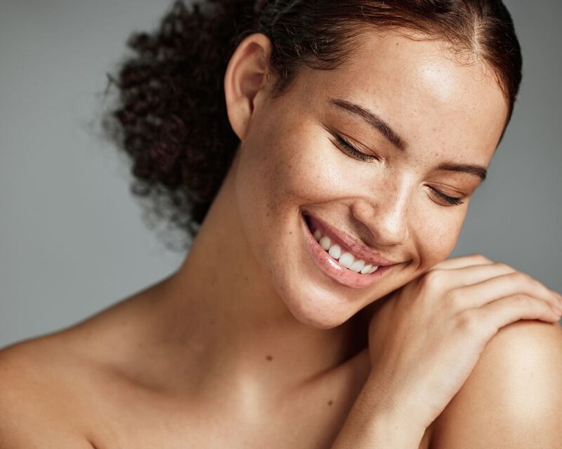 Serene Freckled Woman Smiling Softly