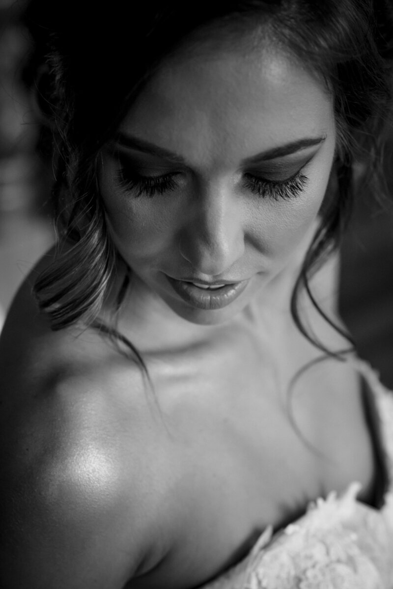 Black-and-white-top-down-view-showing-bride's-romantic-hair-and-makeup