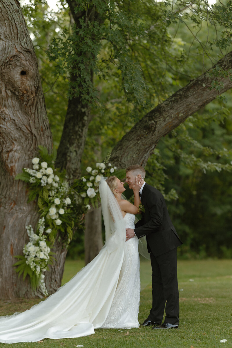 A couple sharing their first kiss at their wedding at Ruttger's Bay Lake Resort in Deerwood, Minnesota
