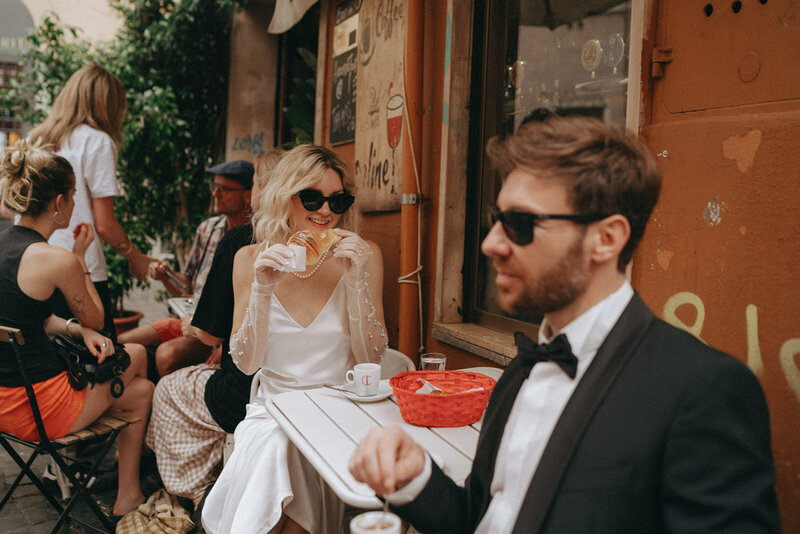 bride and groom eloping in italy at a cafe captured by elsie goodman, a destination and italy wedding photographer