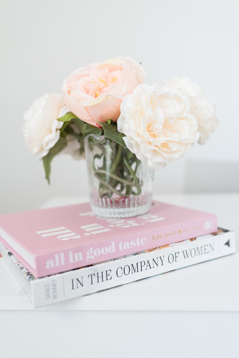 Peonies sitting on top of pink and white book