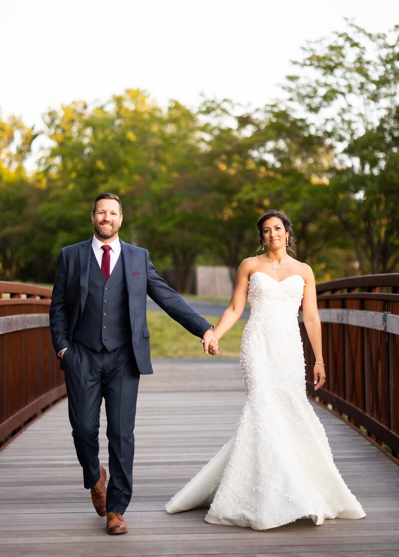 Bride and groom hand in hand on bridge, Baltimore wedding photography