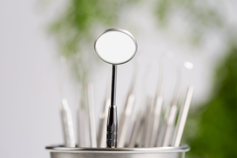 Jar of dental tools and a mirror