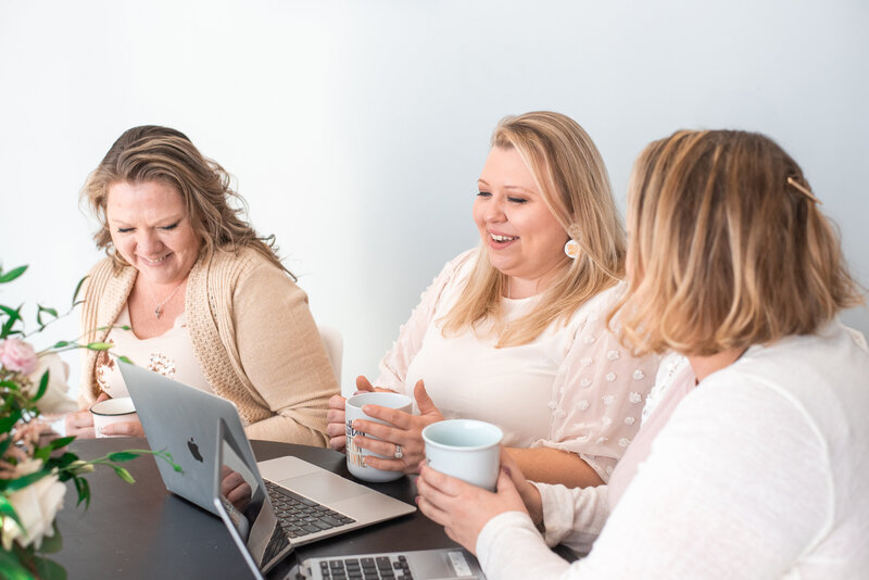 Natasha and Larson Team at table Drinking coffee while working on design proposals