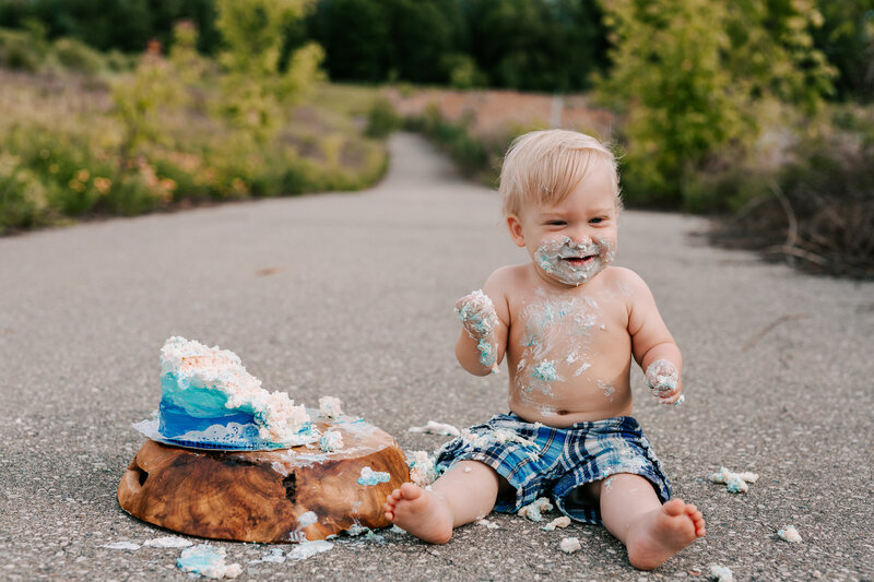 baby eating cake outdoors