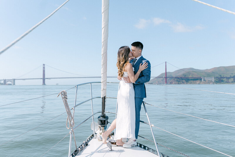 couple embracing on a sailboat on the San Francisco bay