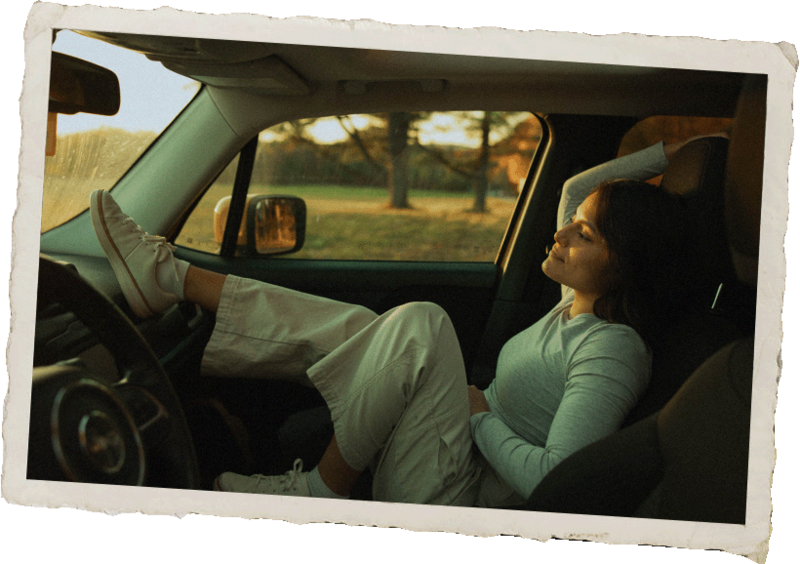 Adventurous portrait of a New York Wedding Photographer in the car at golden hour