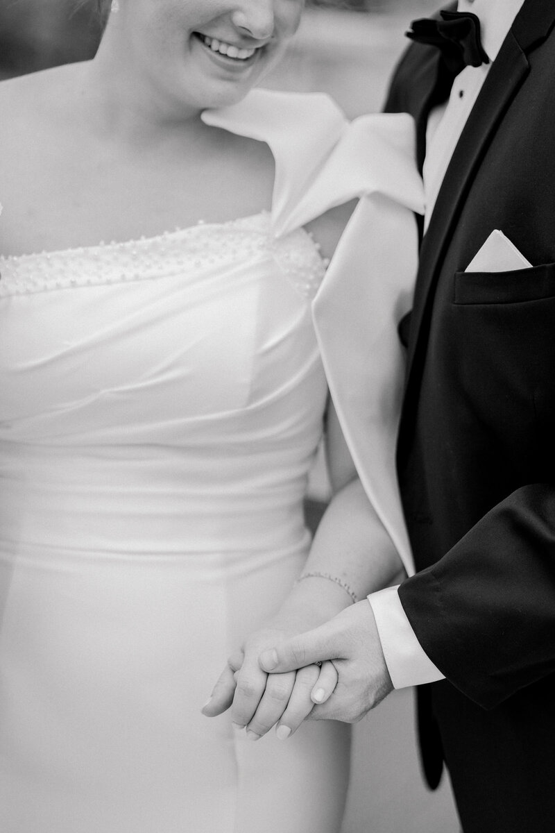 Wedding at the Bristol Train Station in Bristol, VA | Caitlin Wilcox Photography | black and white closeup picture of groom holding bride's hand