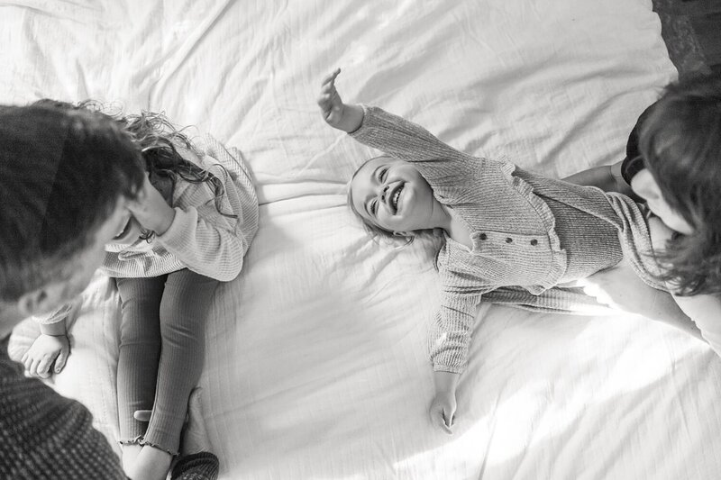 playful image of kids laughing during home family photos by Charlottesville photographer Leah O'Connell