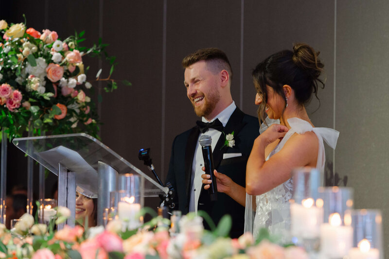 Ottawa wedding photo showing a bride and groom at the podium thanking their guests during the Chateau Le Parc wedding reception