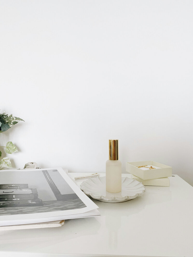 Perfume and magazine with white background