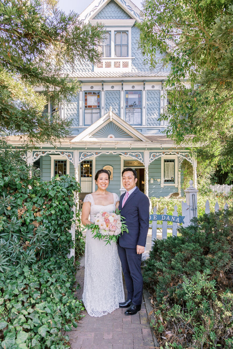 wedding couple in front of venue by Inclusive Santa Barbara wedding photographers Renoda Campbell Photography