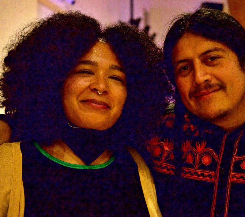 Two artists smiling and posing for the camera