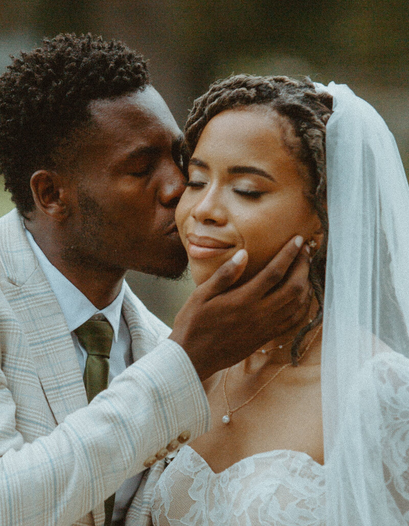 Groom kissing bride on their wedding day