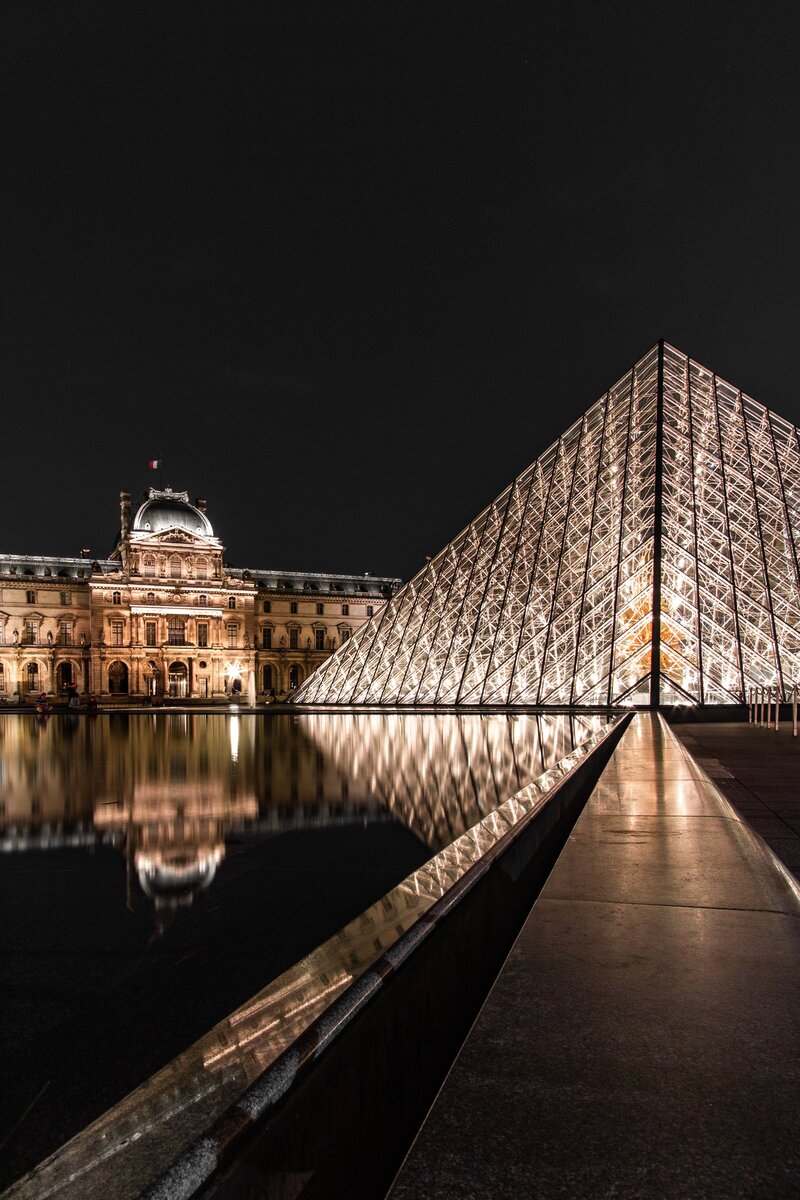 Discover the Louvre Pyramid, a striking glass structure that serves as the main entrance to the Louvre Museum in Paris. Experience its modern design and access the world-renowned art collections inside.