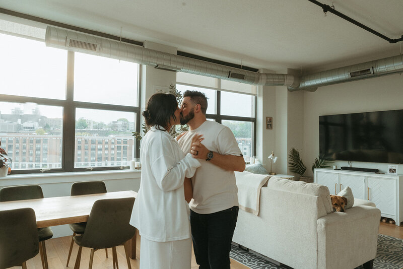 couple kissing at home during maternity photoshoot captured by NYC maternity photographer Elsie Goodman 